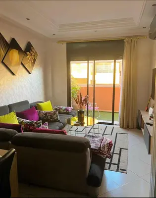 a living room with couches and a table at Nice new apartment in the city center in Marrakech