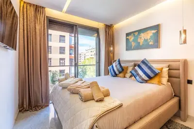 a bedroom with a large bed with a large window at New ! Splendid and cosy apartment in Marrakech