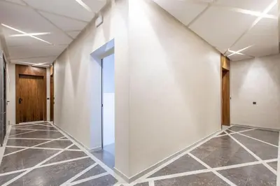 an empty hallway with white walls and tile floors at New ! Splendid and cosy apartment in Marrakech