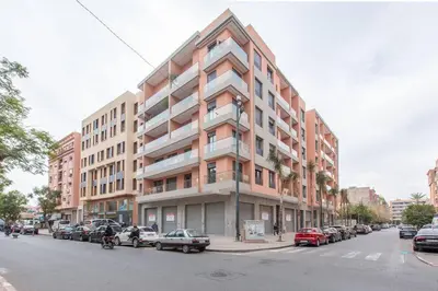 a large building on a city street with parked cars at New ! Splendid and cosy apartment in Marrakech