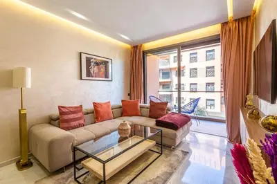 a living room with a couch and a large window at New ! Splendid and cosy apartment in Marrakech