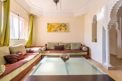 a living room with a couch and a glass table at Appartement 2 chambres in Marrakech