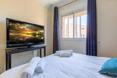 a bedroom with a flat screen tv and a bed at Appartement 2 chambres in Marrakech
