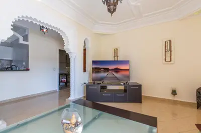 a living room with a tv on a wall at Appartement 2 chambres in Marrakech