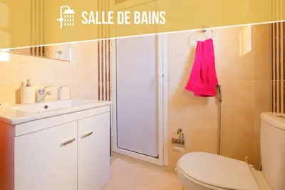 a bathroom with a toilet and a sink and a shower at Residence DES LILAS DAR SALAM chez Madame ASSYL residence avec 3 piscines in Marrakech