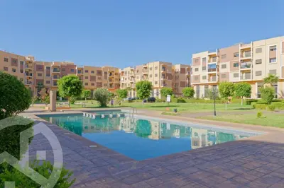 a swimming pool in front of a apartment complex at Residence DES LILAS DAR SALAM chez Madame ASSYL residence avec 3 piscines in Marrakech