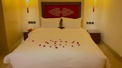 a bedroom with a bed with red hearts on it at Riad Pourpre Medina in Marrakech