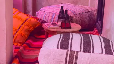 a room with two beds and two bottles on a table at Riad Pourpre Medina in Marrakech
