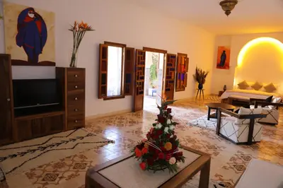 a living room with a television and a christmas tree at Riad Ben in Marrakech