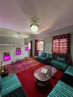 a living room with green couches and a table at Calm appartment close to airport of Marrakech in Marrakech