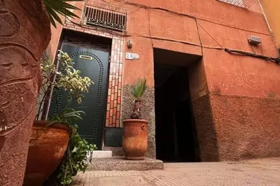 a door with a potted plant in front of a building at Dar Khadija Familly in Marrakech