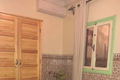 a room with a closet and a window in it at Dar Khadija Familly in Marrakech