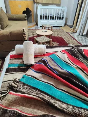a pile of blankets on the floor of a living room at Dar saafia in Marrakech
