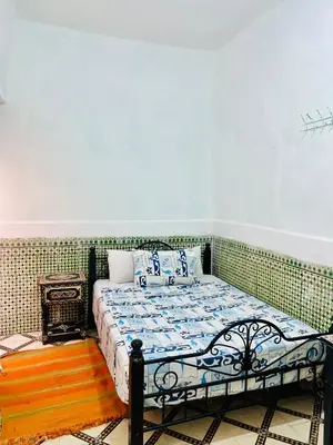 a bedroom with a bed in a room at Dar jamaa lfna in Marrakech