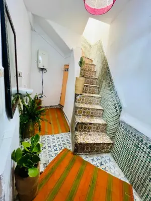 a stairway in a room with plants on it at Dar jamaa lfna in Marrakech