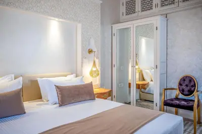 a hotel room with a bed and a chair at Riad Glatt K in Marrakech