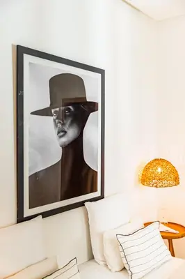 a picture of a woman wearing a hat on a wall at Pure House Marrakech in Marrakech