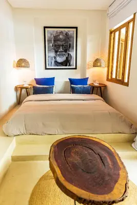a bedroom with a large bed with a wooden bowl on it at Pure House Marrakech in Marrakech