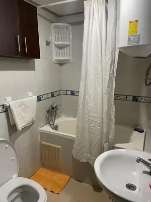 a bathroom with a toilet and a tub and a sink at Appartement 17 3ème étage avec balcon POUR FAMILLE in Marrakech