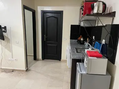 a kitchen with a sink and a black door at Appartement 1er étage numéro 6 POUR FAMILLE in Marrakech