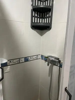a shower in a bathroom with a hose at Appartement 1er étage numéro 7 POUR FAMILLE in Marrakech