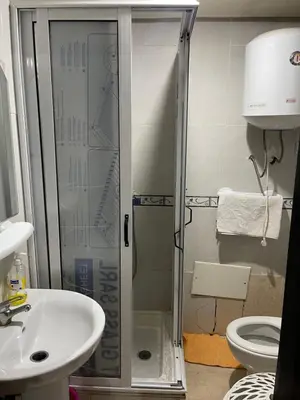a bathroom with a shower and a sink and a toilet at Appartement 1er étage numéro 7 POUR FAMILLE in Marrakech