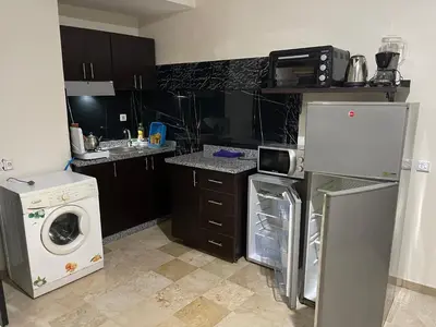 a kitchen with a washing machine and a washer at Appartement 1er étage numéro 7 POUR FAMILLE in Marrakech