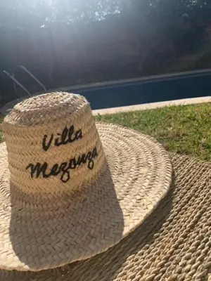 a straw hat sitting on top of a table at Villa Mezouza in Marrakech
