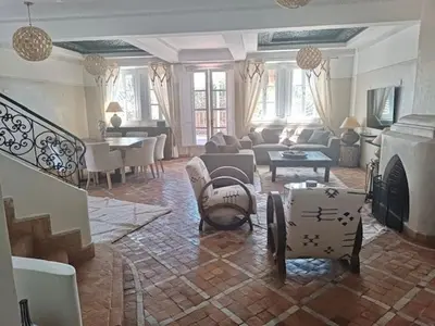 a living room filled with furniture and a fireplace at Villa Mezouza in Marrakech