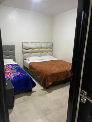 a bedroom with two beds in a room at Appartement 11 2èm étage. (POUR FAMILLE) in Marrakech