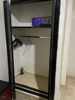 a walk in closet with a glass door at Appartement 11 2èm étage. (POUR FAMILLE) in Marrakech