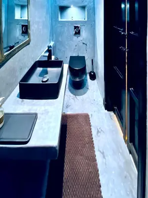 a bathroom with two sinks and a toilet at Chic Moroccan Vibes & Pool View - 2BR in Marrakech