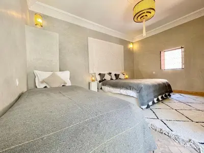 a bedroom with two beds in a room at Riad Jolie in Marrakech