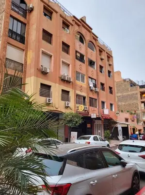 a car parked in front of a tall building at DAR NOUONSA in Marrakech