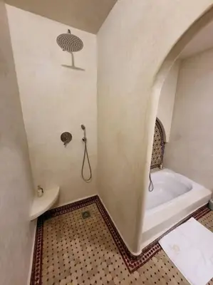 a bathroom with a bath tub and a toilet at DAR NOUONSA in Marrakech
