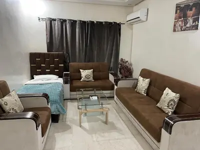 a living room with two couches and a table at Appartement 13 2em étage POUR FAMILLE in Marrakech