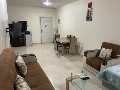 a living room with a couch and a table at Appartement 13 2em étage POUR FAMILLE in Marrakech
