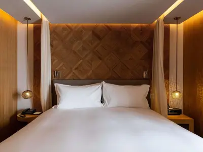 a bedroom with a large bed with white pillows at Sofitel Marrakech Palais Impérial & Spa in Marrakech