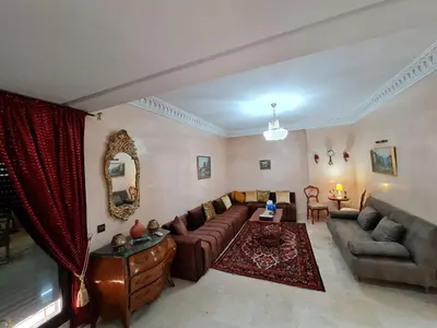 a living room with a couch and a table at Luxury apartment 2 in the heart of Gueliz, Wifi, Pool in Marrakech