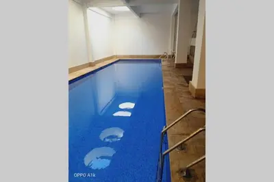a swimming pool with blue water in a room at Luxury apartment 2 in the heart of Gueliz, Wifi, Pool in Marrakech