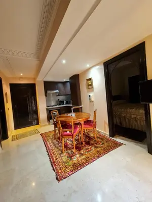 a dining room with a table and chairs on a rug at Luxury apartment 2 in the heart of Gueliz, Wifi, Pool in Marrakech