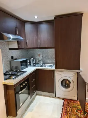 a kitchen with a sink and a washing machine at Luxury apartment 2 in the heart of Gueliz, Wifi, Pool in Marrakech