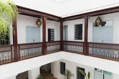 a balcony of a house with wooden railing at Riad Vivre - Design Boutique Riad in Marrakech in Marrakech