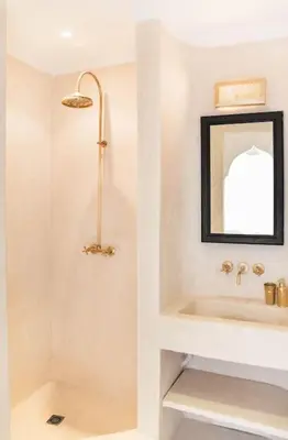 a bathroom with a shower and a sink and a mirror at Riad Vivre - Design Boutique Riad in Marrakech in Marrakech