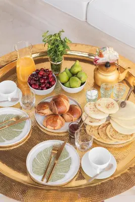 a tray filled with plates of food on a table at Riad Vivre - Design Boutique Riad in Marrakech in Marrakech