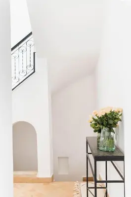 a table with a vase of flowers on it at Riad Vivre - Design Boutique Riad in Marrakech in Marrakech