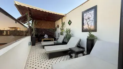 a patio with chairs and tables on a building at Dar Najat in Marrakech