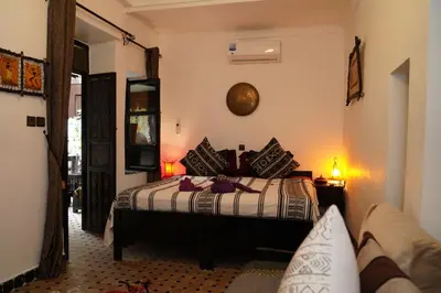 a bedroom with a bed and a couch at Dar Najat in Marrakech