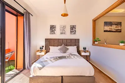 a bedroom with a bed and a large window at favorite in the city center - 100% Equipped in Marrakech