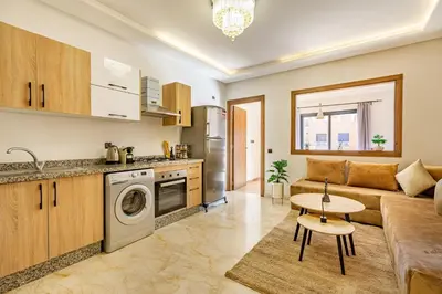 a kitchen and living room with a couch and a table at favorite in the city center - 100% Equipped in Marrakech